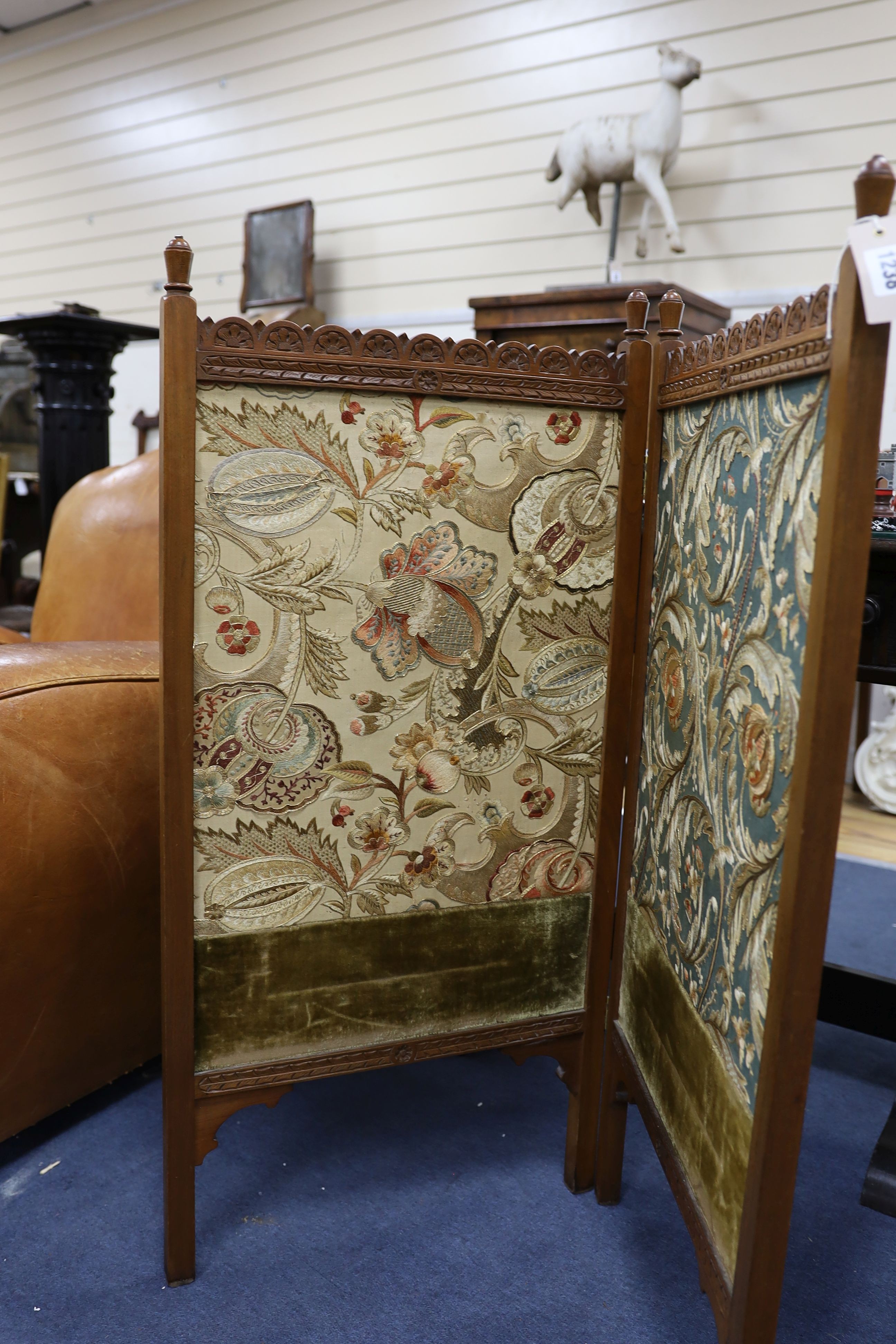 An Arts and Crafts Morris-style embroidered two-fold mahogany framed screen, each panel width 47cm, height 97cm, the embroidery design in the manner of May Morris